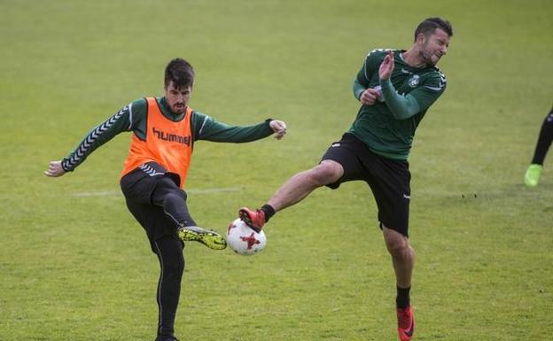 Álex García, descartado por Pouso, estrella el balón en el pie de Borja Lázaro en la sesión del miércoles./Javier Cotera