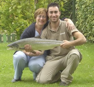 Manuel Barreiro Mier posa junto a su madre con el salmón que pescó con un aparejo de trucha en la zona libre de Renedo, en el Pas. ::
F. DE LA I./